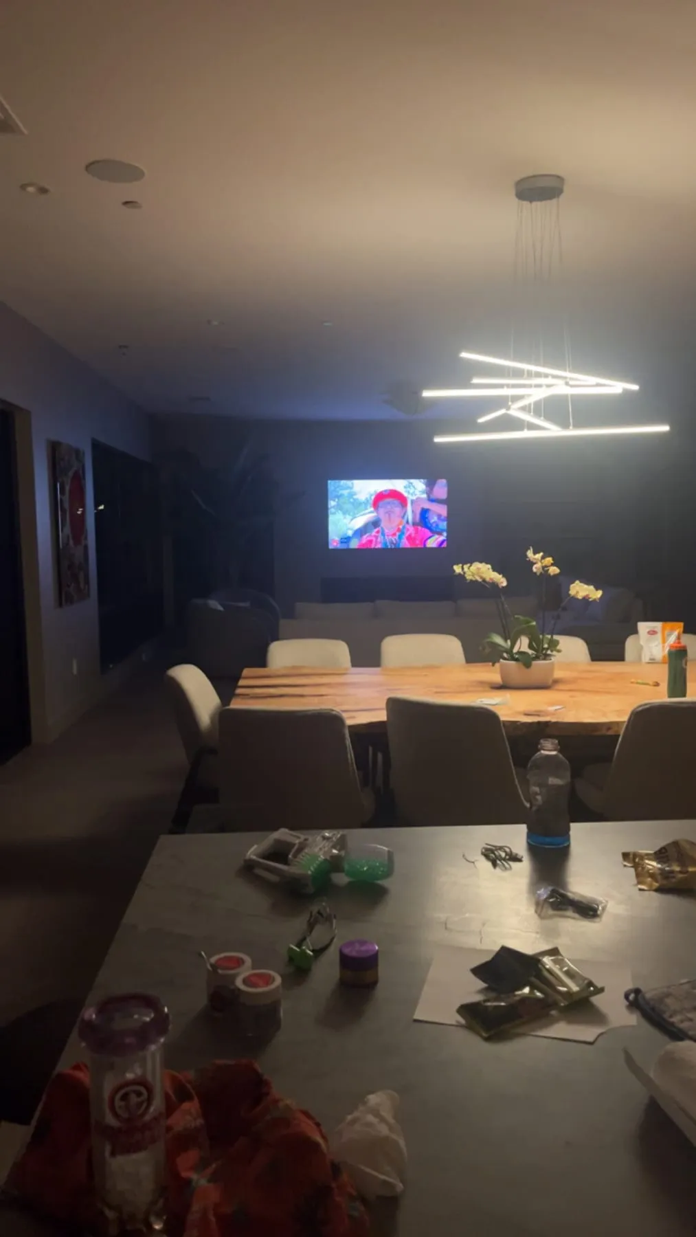 A modern dining room and living space at night